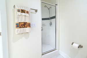 Full bath featuring a stall shower and tile patterned floors