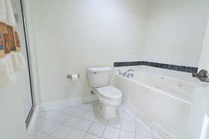 Bathroom featuring tile patterned flooring, a bath, and a stall shower