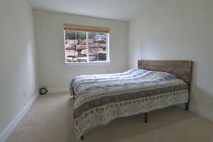 Carpeted bedroom with baseboards