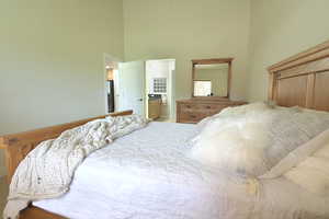 Bedroom with a high ceiling and ensuite bath