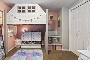 Carpeted bedroom with baseboards and a textured ceiling