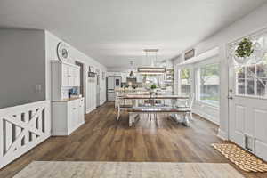 Dining space featuring dark wood-style floors