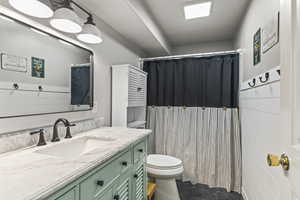 Full bath with vanity and a shower with curtain