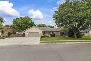 Ranch-style house with an attached garage, brick siding, and concrete driveway