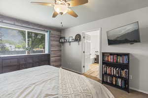 Bedroom featuring ceiling fan and ensuite bath