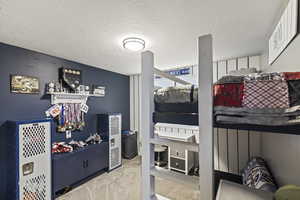 Carpeted bedroom featuring a textured ceiling