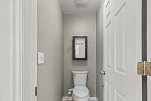 Bathroom with baseboards and a textured ceiling
