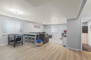 Recreation room featuring wood finished floors and plenty of natural light