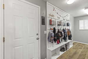 Mudroom featuring wood finished floors and a textured ceiling