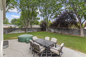 Fenced backyard with a patio and outdoor dining space