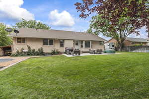 Rear view of property with stucco siding and a patio area