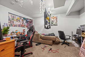 Bedroom featuring carpet and a textured ceiling