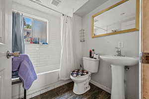 Full bathroom with shower / bath combo and a textured ceiling