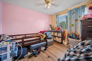 Bedroom featuring wood finished floors and ceiling fan