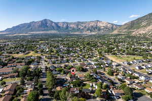 View of property location featuring mountains and nearby suburban area
