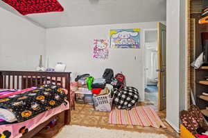 Bedroom with a textured ceiling