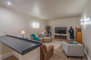 Living room with carpet floors and baseboards