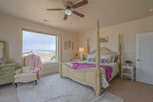 Bedroom with light carpet and ceiling fan