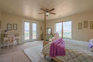 Bedroom with access to exterior, carpet flooring, ceiling fan, and a textured ceiling