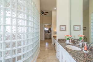 Full bathroom featuring vanity, tile patterned flooring, ceiling fan, a high ceiling, and recessed lighting