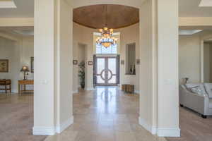 Entrance foyer featuring a chandelier and light tile patterned flooring