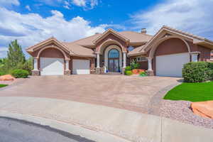 Mediterranean / spanish-style house with stucco siding, an attached garage, concrete driveway, and a tiled roof