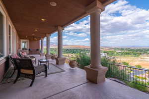 Patio / terrace with a ceiling fan and a mountain view
