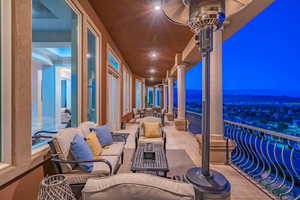 Patio at twilight with a balcony and an outdoor living space