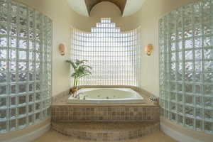 Full bathroom with a jetted tub and tile patterned floors