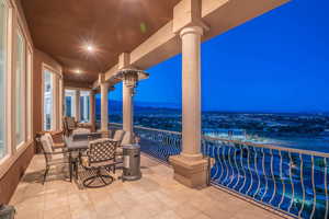 Balcony at night with outdoor dining area
