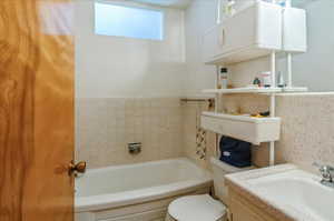 Full bathroom featuring a bathtub and vanity