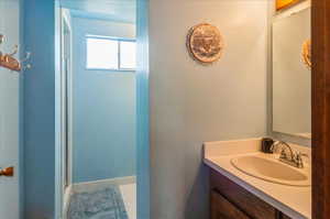 Bathroom featuring vanity and an enclosed shower