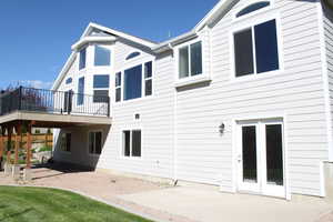Rear view of property featuring a patio area and a deck