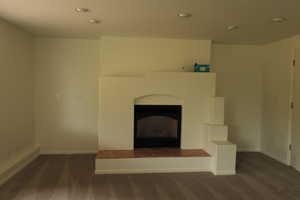 Unfurnished living room with carpet floors and a fireplace
