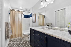 Fully updated main floor bathroom with granite counter, large vanity, and beautifully patterned  tile floors