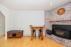 Dining space featuring wood-burning stove and brick hearth