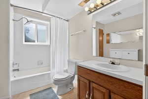 Full bathroom featuring vanity and shower / bath combination with curtain