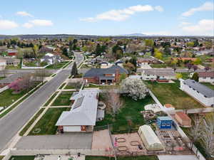 Aerial perspective of side of house showing the huge .5 acre lot, work shed, patio and garden.