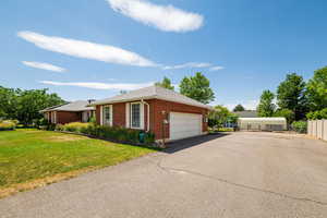 East side of home featuring large 2 car garage and lots of extra parking.