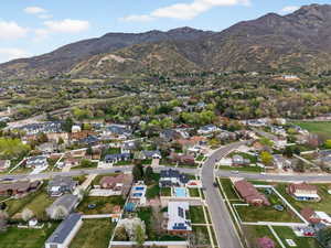 Aerial overview of property's location with nearby suburban area and a mountain backdrop