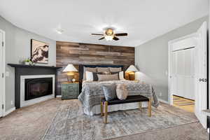 Primary bedroom with a fireplace, wood accent wall, brand new carpet, and French door access to hot tub.