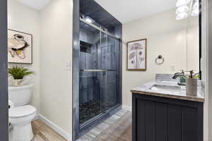 Fully updated en-suite primary bathroom with double vanity, a double shower, and a walk-in closet