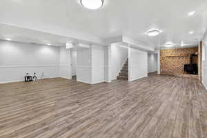 Large, finished basement with updated flooring and a wood-burning stove.