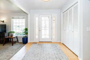 Entryway with hardwood flooring and baseboards