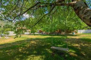 Almost 1/2 acre lot w fenced yard, deck, fire pit, mature fruit trees.