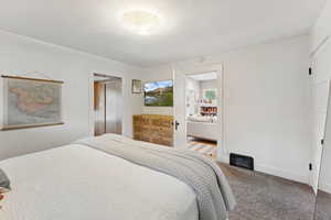 Bedroom featuring carpet and baseboards
