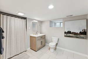 Full bath featuring vanity, a shower with curtain, and tile patterned floors