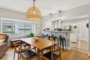 Dining room featuring plenty of natural light, light wood-type flooring, and recessed lighting