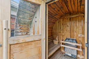 Sauna / steam room featuring wood-type flooring and wood walls