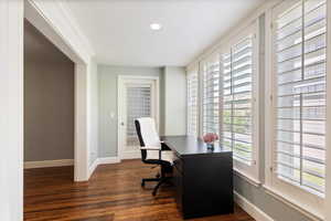 Office area featuring dark wood finished floors and recessed lighting